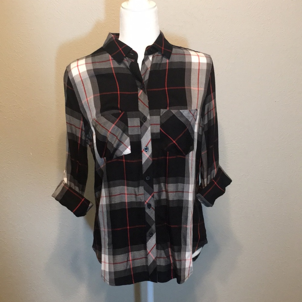 Plaid top with rolled and buttoned sleeves.